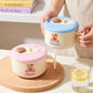 Bear stainless steel lunch box with handle and spoon in pastel pink and blue.