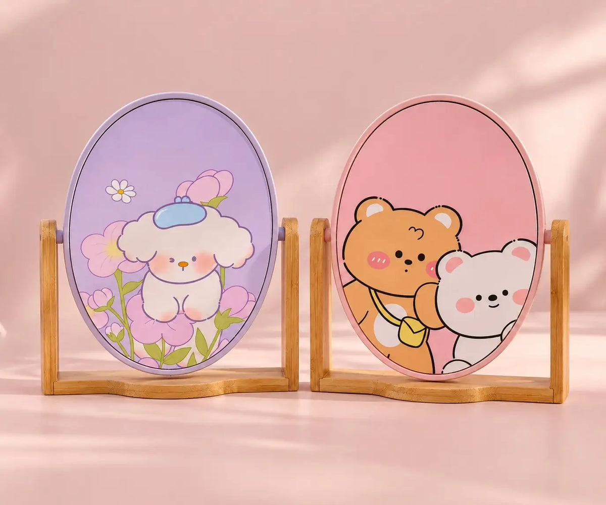 Kawaii oval tabletop mirrors with cute pastel character designs and wooden stands on a soft pink background.