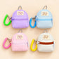 Four quilted mini backpack keychains arranged in a 2x2 grid on a light beige background. Each backpack has a different pastel color: lavender purple, light blue, pink, and off-white.